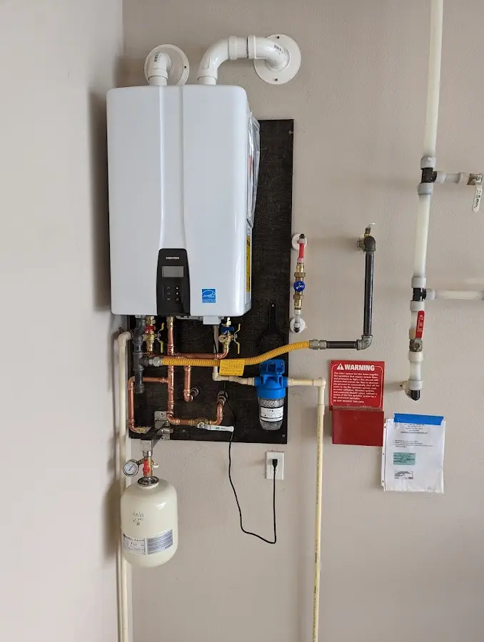 Professional plumber installing copper piping in a Tea home